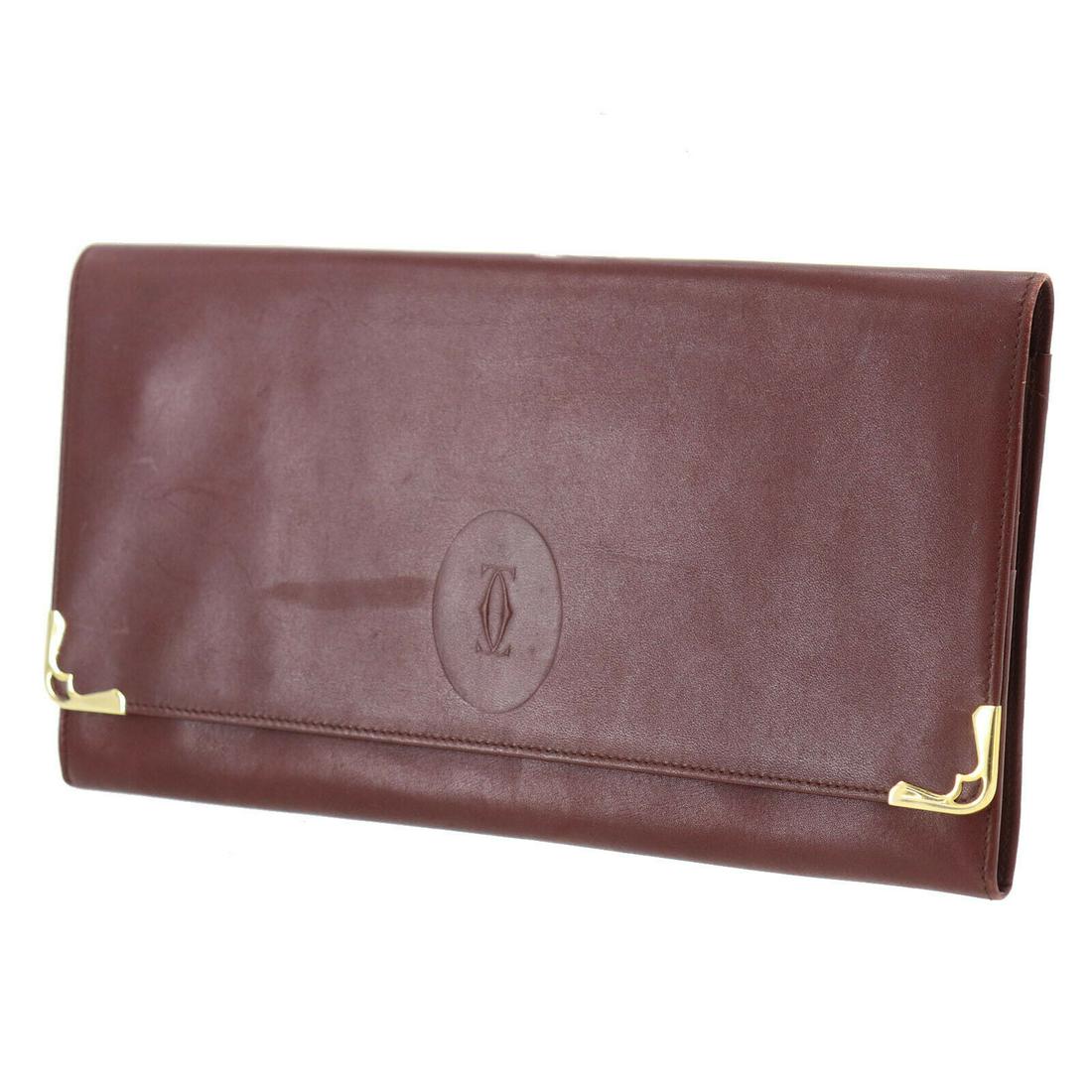 Authentic CARTIER Logos Must Line Clutch Bag: Brand: CARTIER Material: Leather Style: Clutch Color: Bordeaux Size(Inch): H 6.2 x D 0.7 x L 11.0 Country of Origin: Italy All Bidhaus items come with a 100% money-back authenticity guarantee. Please 