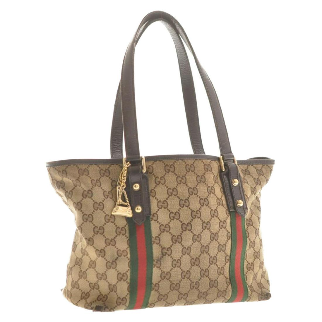 Authentic GUCCI GG Canvas Sherry Line Charm Tote: Brand: GUCCI Material: GG Canvas Style: Tote Bag Color: Red / Green Size(inch): W10.23 x H8.26 x D5.11inch(Approx) Country of Origin: Italy Accessory: Charm All Bidhaus items come with a 100% money-ba