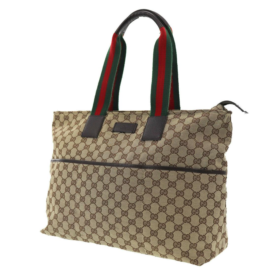 Authentic GUCCI Original GG Canvas Tote Hand Bag Brown: Brand: Gucci Material: Canvas Style: Hand Bag Color: Brown Size(Inch): H 11.8 x D 4.7 x L 18.8 Handle : 21.2 Country of Origin: Italy Come with: - All Bidhaus items come with a 100% money-back authent