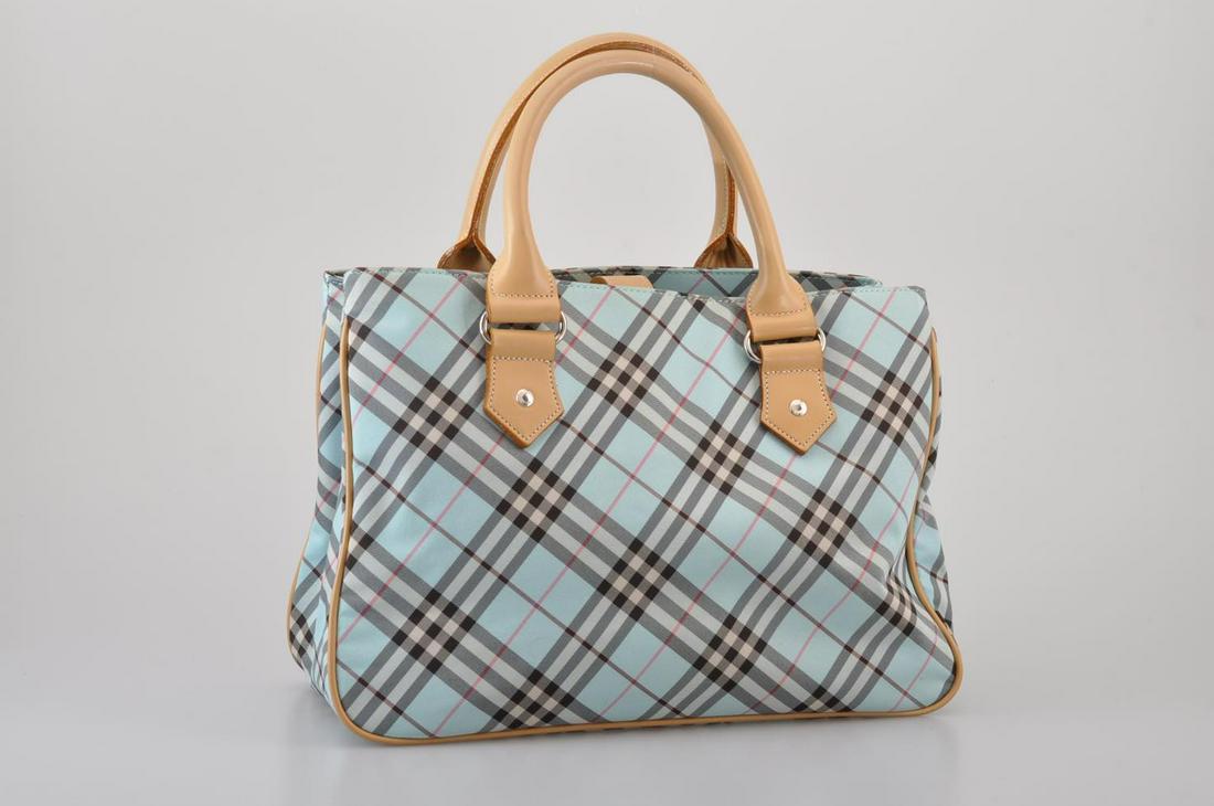 Authentic Burberry Blue Label Nylon Hand Bag: Brand: Burberry Style: Hand Bag Material: Nylon Color: Light Blue Size (Inches): W11.81 X H7.48 X D5.51Inch(Approx) Exterior Condition: Nylon : Minor Loose ShapeLeather : Minor Signs Of AgingMetal Fit