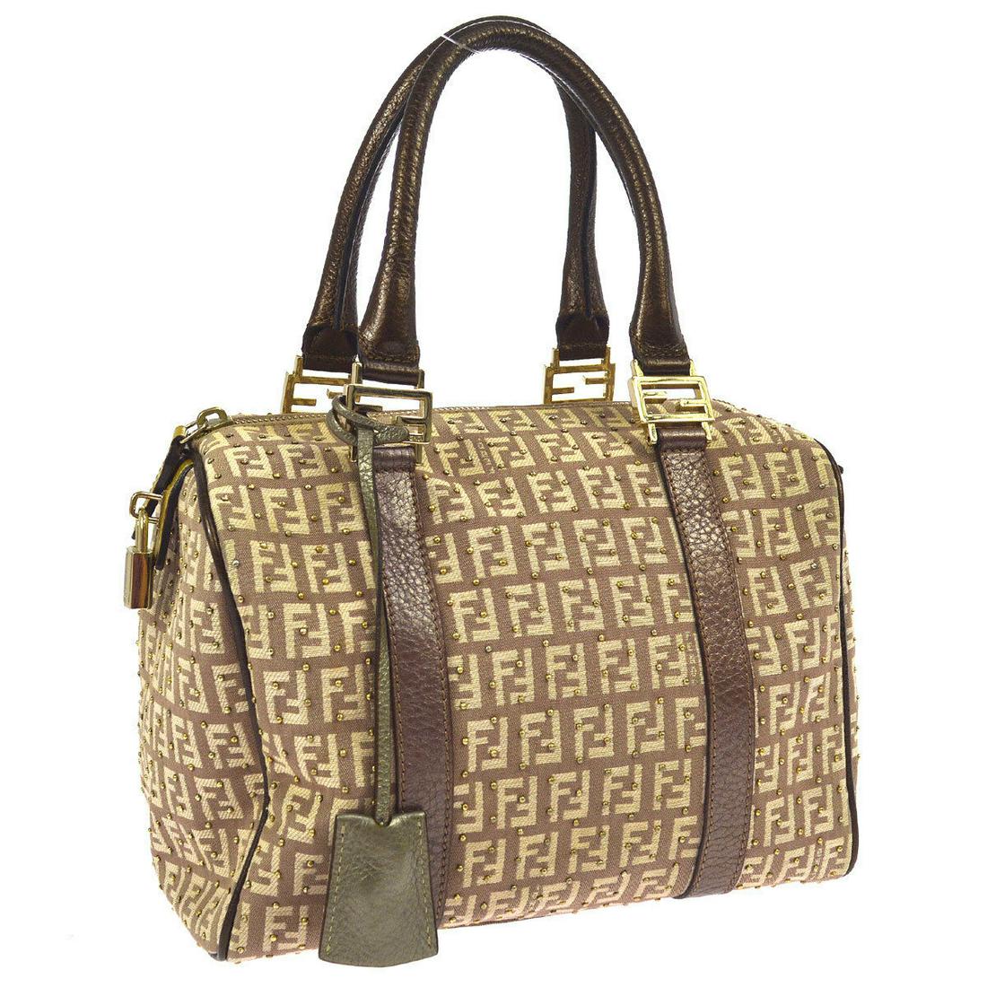Authentic FENDI Zucchino Logos Hand Bag: Brand: FENDI Material: Canvas, Leather Style: Hand Bag Color: Brown, Bronze Size(inch): W9.6 x H7.1 x D5.5 " Country of Origin: Italy Come with: Padlock, Keys*2, Cover of Keys*2 All Bidhaus items come