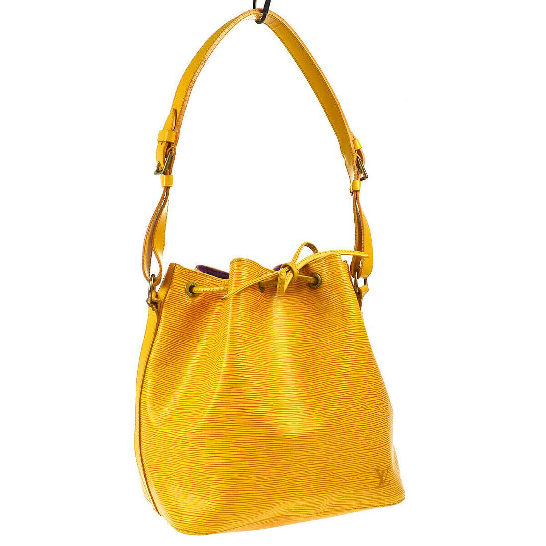 Authentic LOUIS VUITTON PETIT NOE DRAWSTRING SHOULDER: Brand: LOUIS VUITTON Material: Epi Leather, Leather Style: Shoulder Bag Color: Yellow Size(inch): W9.8 x H10.6 x D7.5 " / Strap Drop: 7.9-11.0 Country of Origin: France Come with: Dust Bag All Bidhaus
