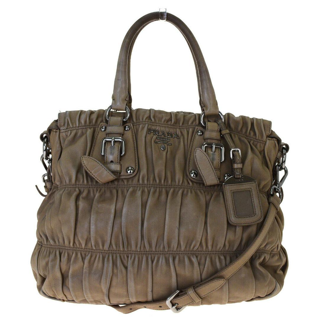 Authentic PRADA Leather Shoulder bag: Brand: PRADA Material: Leather Style: Shoulder bag Color: Brown Size(inch): W 11.8 x H 10.2 x D 6.7 "(approx.) Country of Origin: Italy Come with: - All Bidhaus items come with a 100% money-back authe