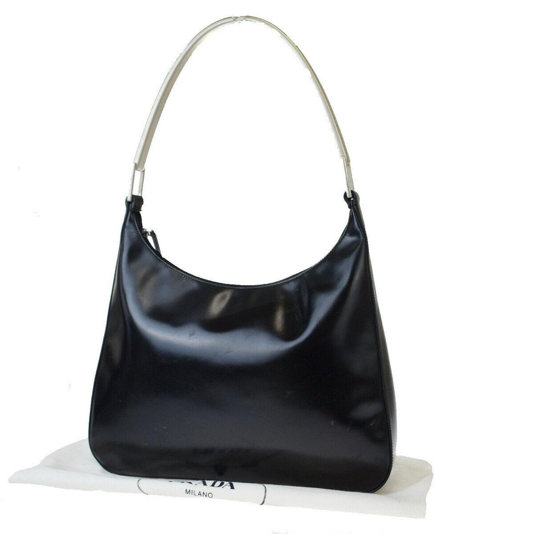 Authentic PRADA Leather, Metal Shoulder Bag: Brand: PRADA Material: Leather, Metal Style: Shoulder Bag Color: Black Size(inch): W 13.4 x H 9.1 x D 2.4 "(approx.) Country of Origin: Italy Come with: Dust bag All Bidhaus items come with a 100% mon