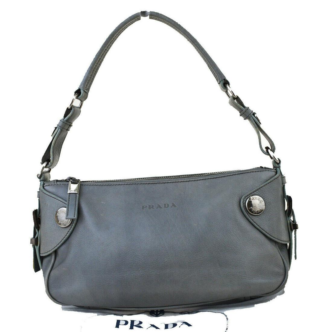 Authentic PRADA Leather Shoulder Bag: Brand: PRADA Material: Leather Style: Shoulder Bag Color: Gray Size(inch): W 10.2 x H 5.9 x D 2.8 "(approx.) Country of Origin: Italy Come with: Dust bag All Bidhaus items come with a 100% money-back