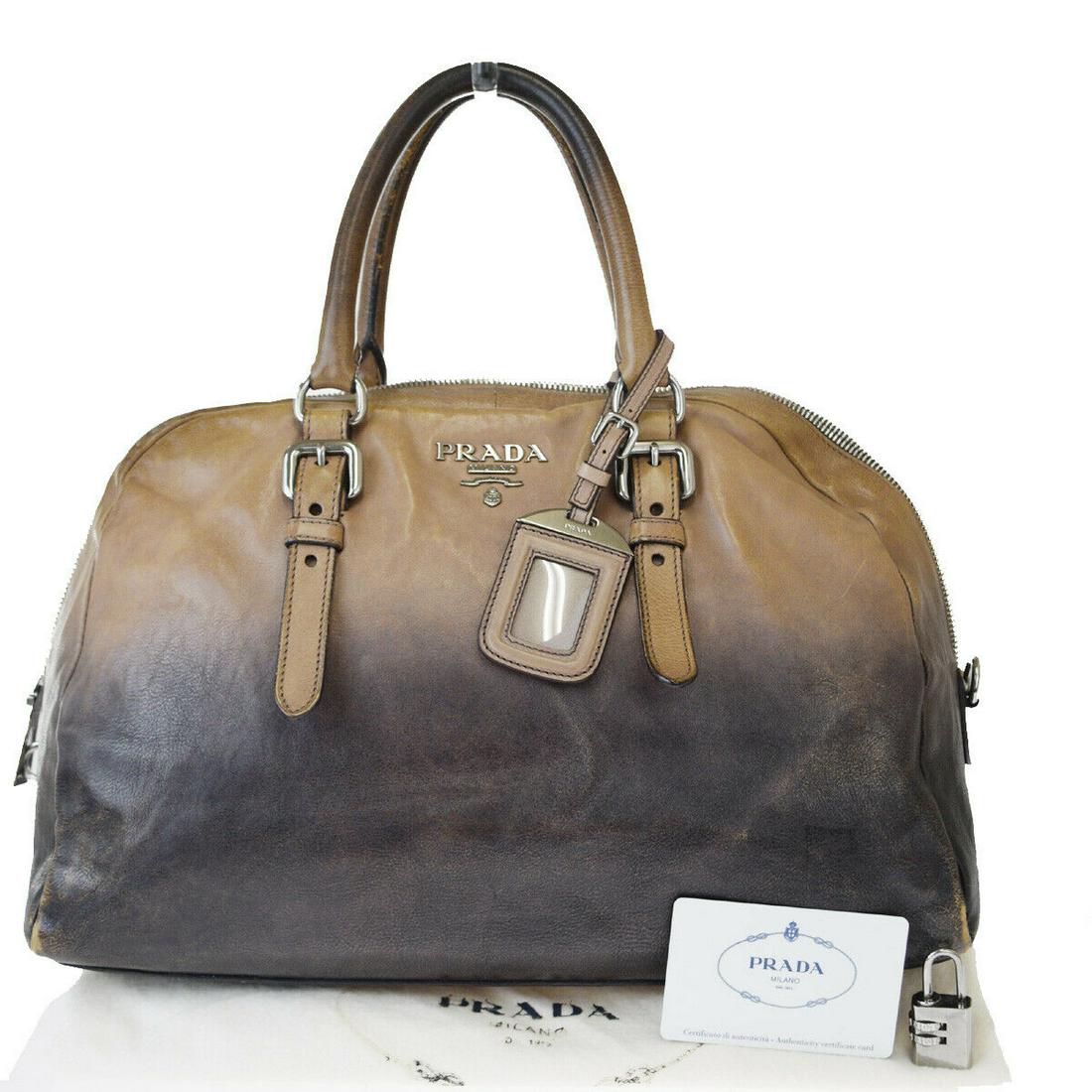 Authentic PRADA Leather Hand Bag: Brand: PRADA Material: Leather Style: Hand Bag Color: Beige Size(inch): W 13.8 x H 9.4 x D 6.3 "(approx.) Country of Origin: Italy Come with: Name tag,Dust bag,Padlock All Bidhaus items come with a 10
