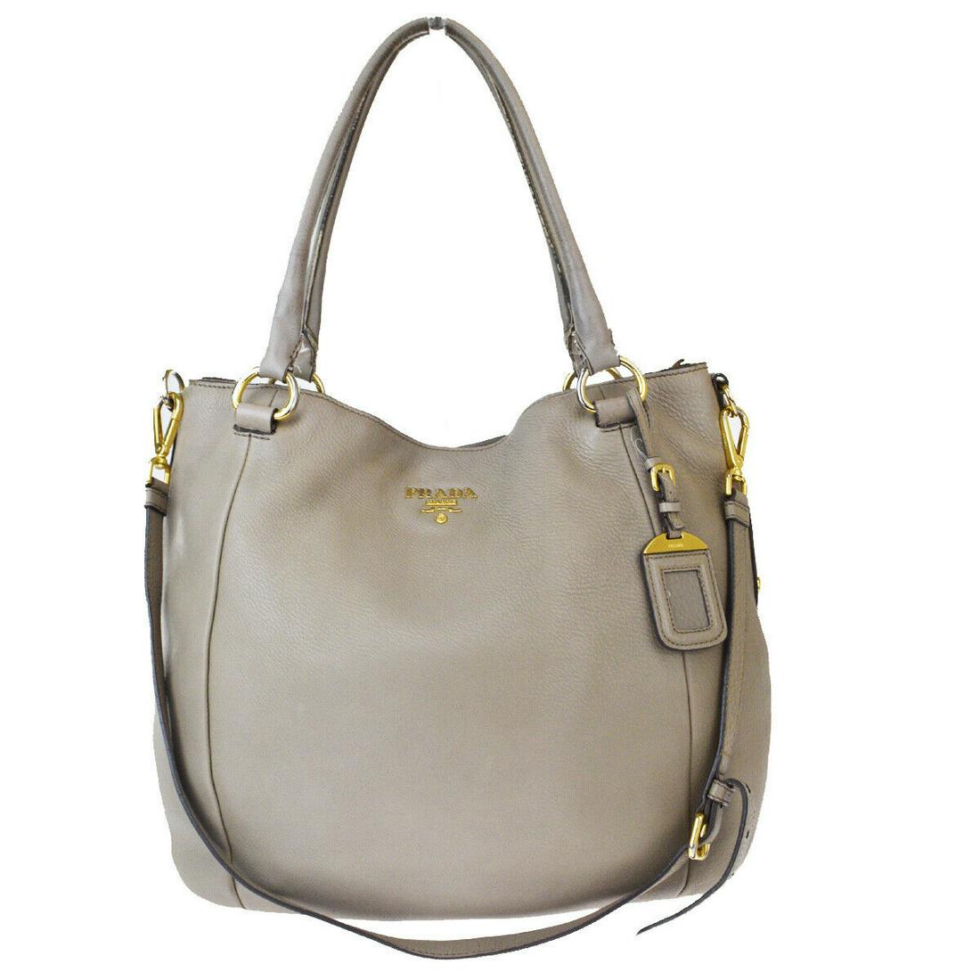 Authentic PRADA Leather Shoulder Bag: Brand: PRADA Material: Leather Style: Shoulder Bag Color: Beige Size(inch): W 13.8 x H 13 x D 5.9 "(approx.) Country of Origin: Italy Come with: Name tag,Shoulder strap All Bidhaus items come with a 1