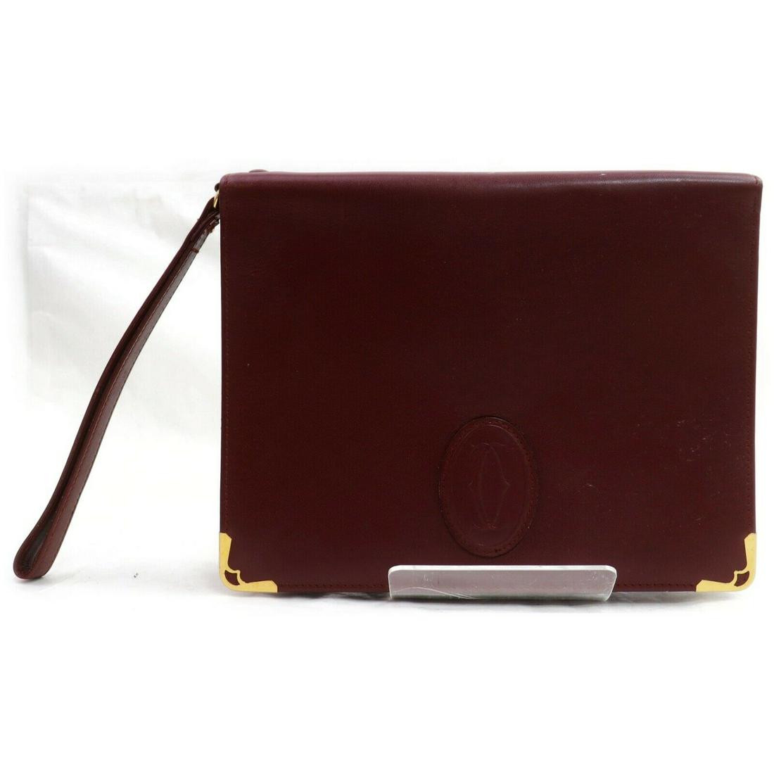 Authentic CARTIER Leather Clutch: Brand: CARTIERMaterial: LeatherStyle: ClutchColor: BordeauxSize(inch): W8.66 inch(approx) /22 cm(approx) x H6.69 inch(approx) /17 cm(approx) x D1.18 inch(approx) /3 cm(approx) "All Bidhaus items come 