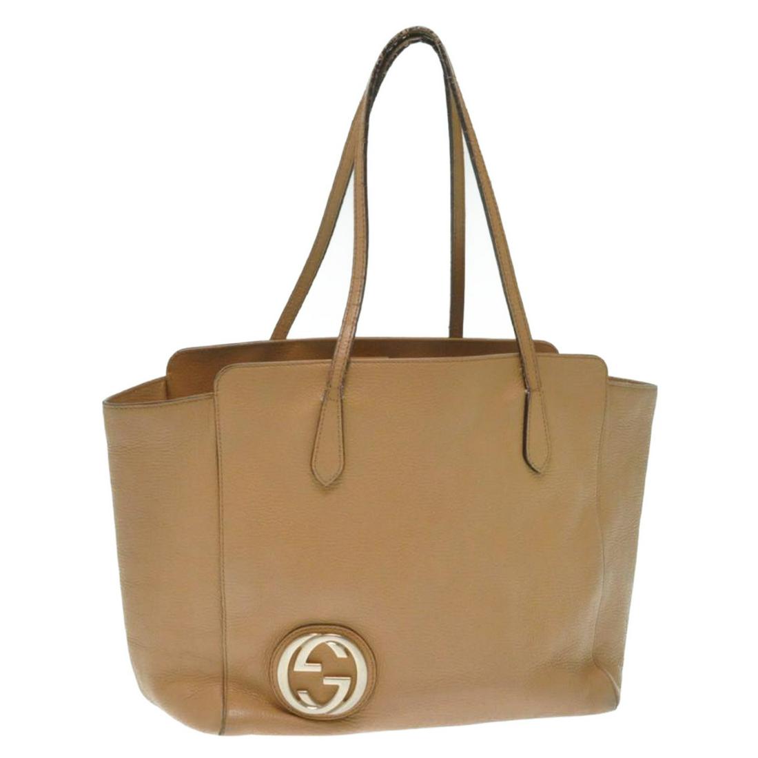 Authentic Gucci Leather Interlocking Tote Bag: Brand: Gucci Style: Tote Bag Material: Leather Color: Brown Made In: Italy Size (Inches): W13.38 X H10.62 X D6.29Inch(Approx) Exterior Condition: Leather : minor Rubbing, signs of aging Handle : Crack