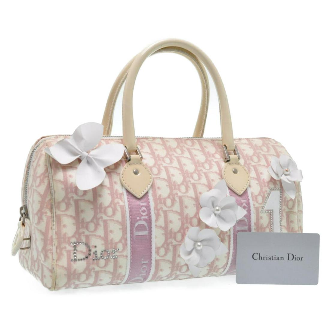 Authentic CHRISTIAN DIOR Flower Trotter Canvas Hand Bag: Brand: CHRISTIAN DIOR Material: Canvas Style: Hand Bag Color: Pink Size(inch): W11.02 x H5.51 x D5.11inch(Approx) Country of Origin: Italy Accessory: Instruction Manual Card / Guarantee Card All Bidha