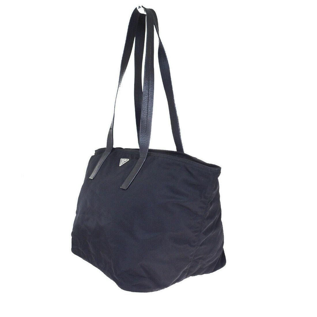 Authentic Prada Nylon, Leather Shoulder bag: Brand: Prada Material: Nylon, Leather Style: Shoulder bag Color: Black Size (HxWxD): 26cm x 28cm x 24cm / 10.23'' x 11.02'' x 9.44'' Country of Origin: Italy All Bidhaus items come with a 100% money-b