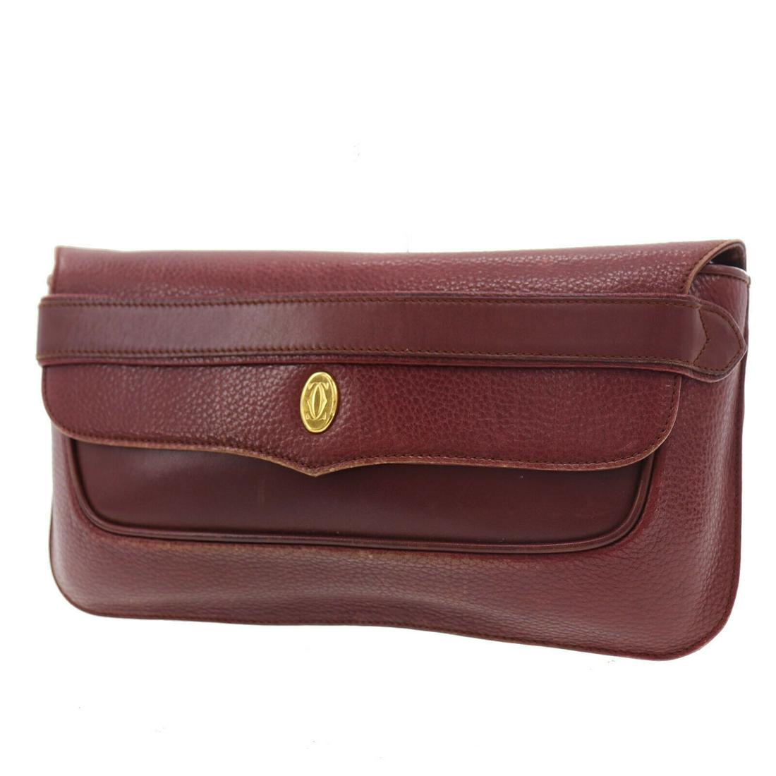 Authentic CARTIER Logos Must Line Clutch Bag: Brand: CARTIER Material: Leather Style: Clutch Color: Bordeaux Size(Inch): H 6.2 x D 1.1 x L 10.8 Country of Origin: Spain Come with: - All Bidhaus items come with a 100% money-back authenticity guara