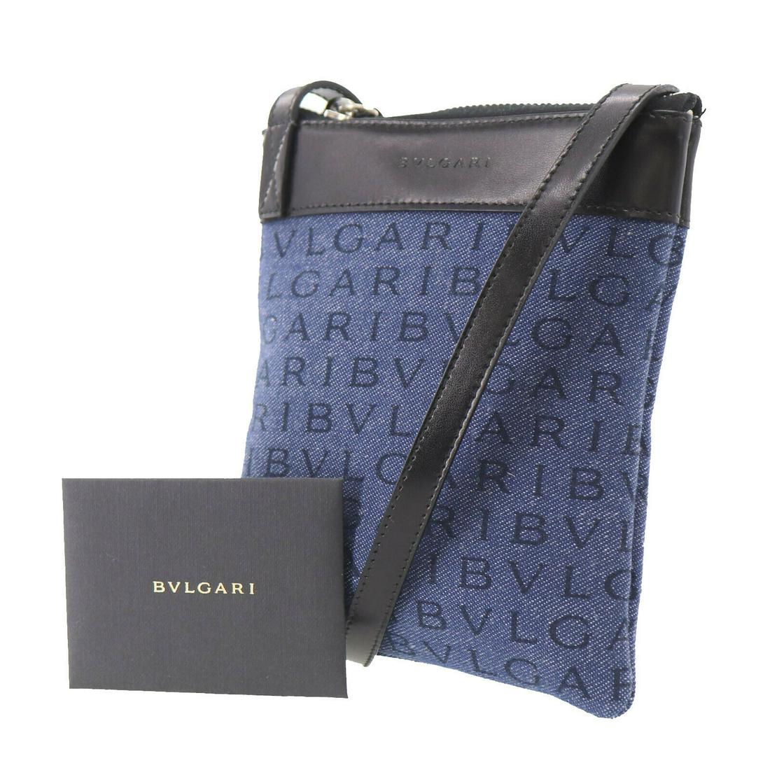 Authentic BVLGARI Logomania Shoulder Pouch Bag: Brand: Bvlgari Material: Canvas Style: Shoulder Bag Color: Navy Black Size(Inch): H 6.6 x D 0.7 x L 5.9 Shoulder : 46.0 Country of Origin: Italy Come with:Authenticity Card Instruction Card All Bidhau