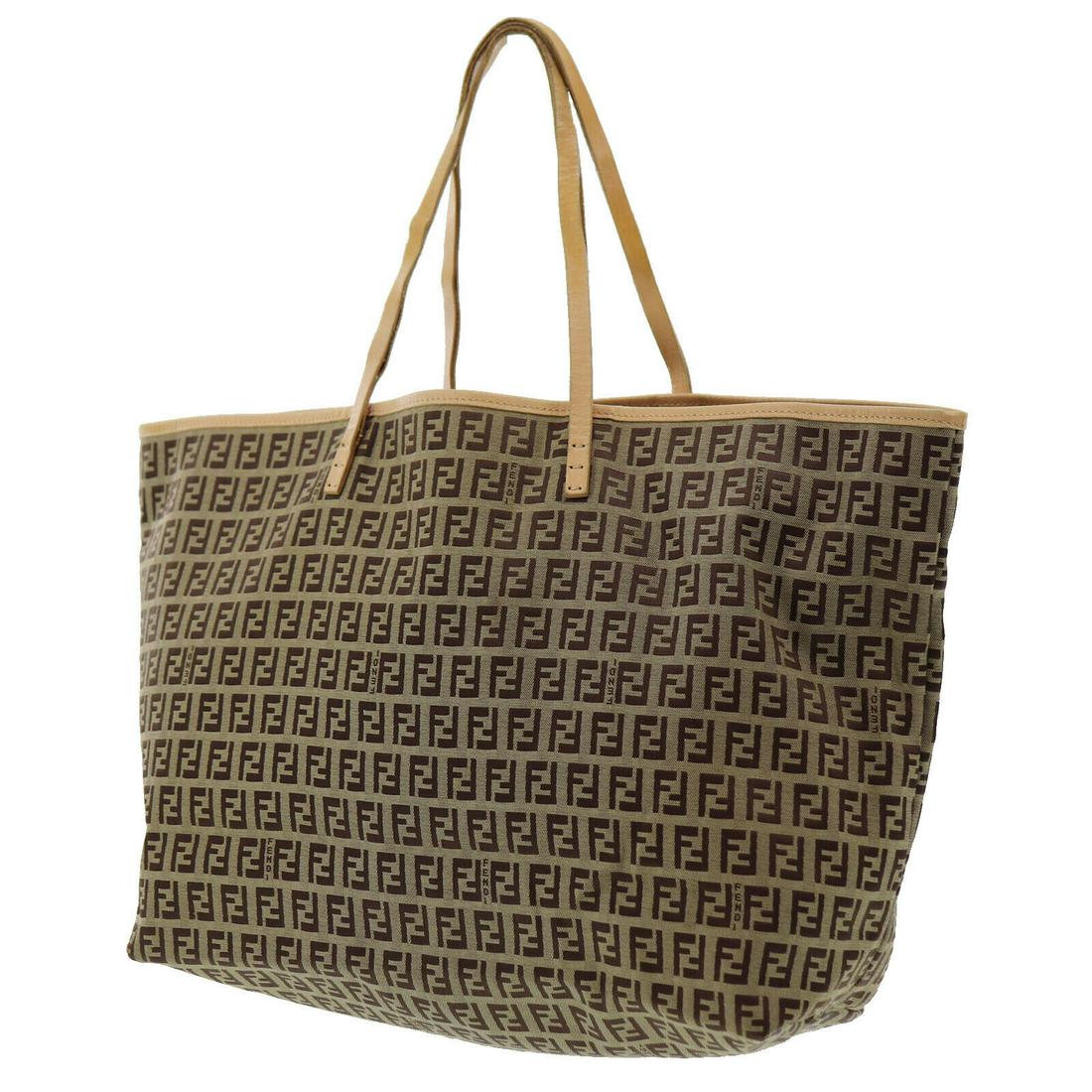 Authentic FENDI Zucca Pattern Tote Hand Bag: Brand: Fendi Material: Canvas Leather Style: Hand Bag Color: Brown, Beige Size(Inch): H 10.6 x D 5.1 x L 13.1 Handle : 20.8 Country of Origin: Italy Come with: - All Bidhaus items come with a 100% mon