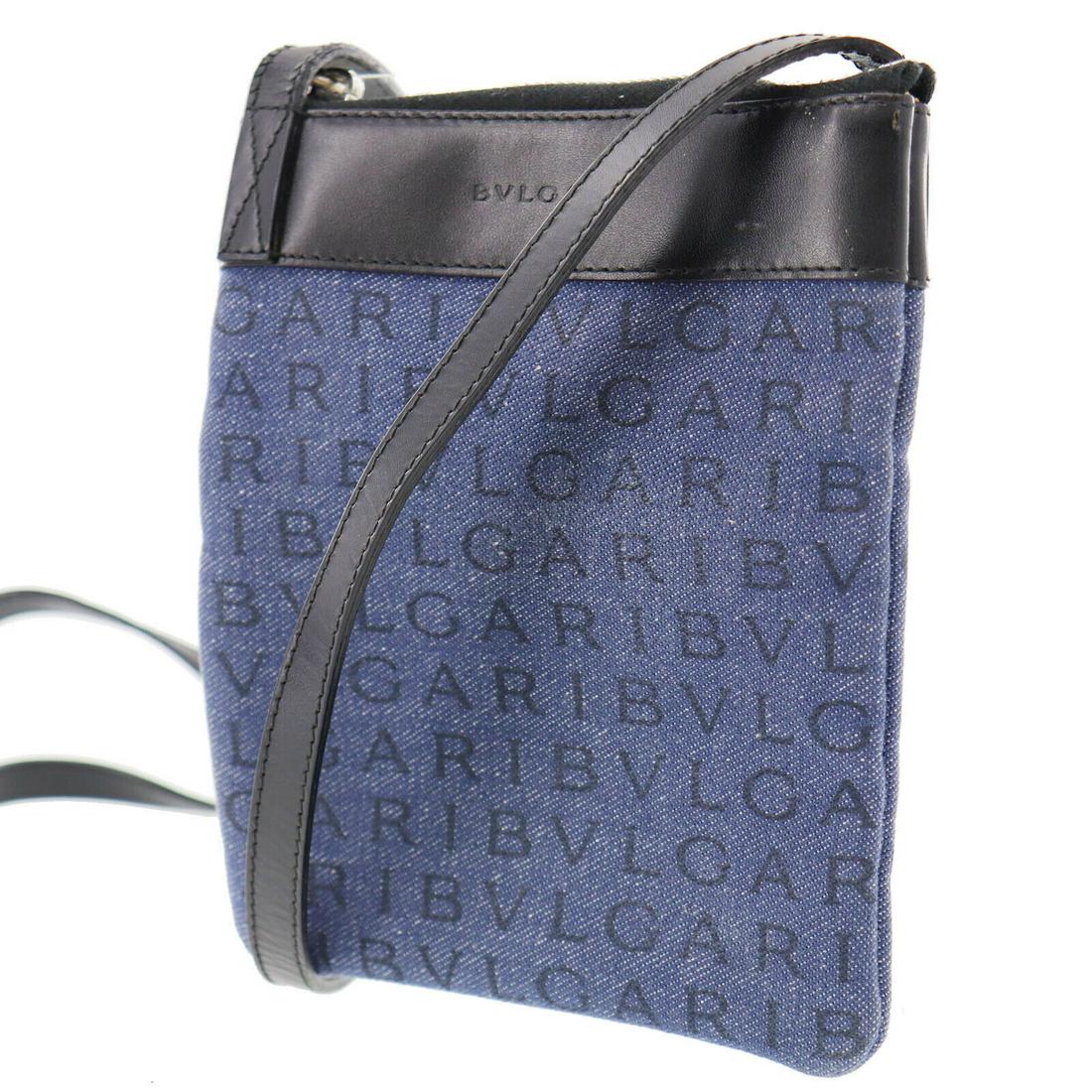 Authentic BVLGARI Logomania Shoulder Pouch Bag: Brand: Bvlgari Material: Canvas Style: Shoulder Bag Color: Navy Black Size(Inch): H 6.6 x D 0.7 x L 5.9 Shoulder : 46.0 Country of Origin: Italy Come with:- All Bidhaus items come with a 100% money-ba