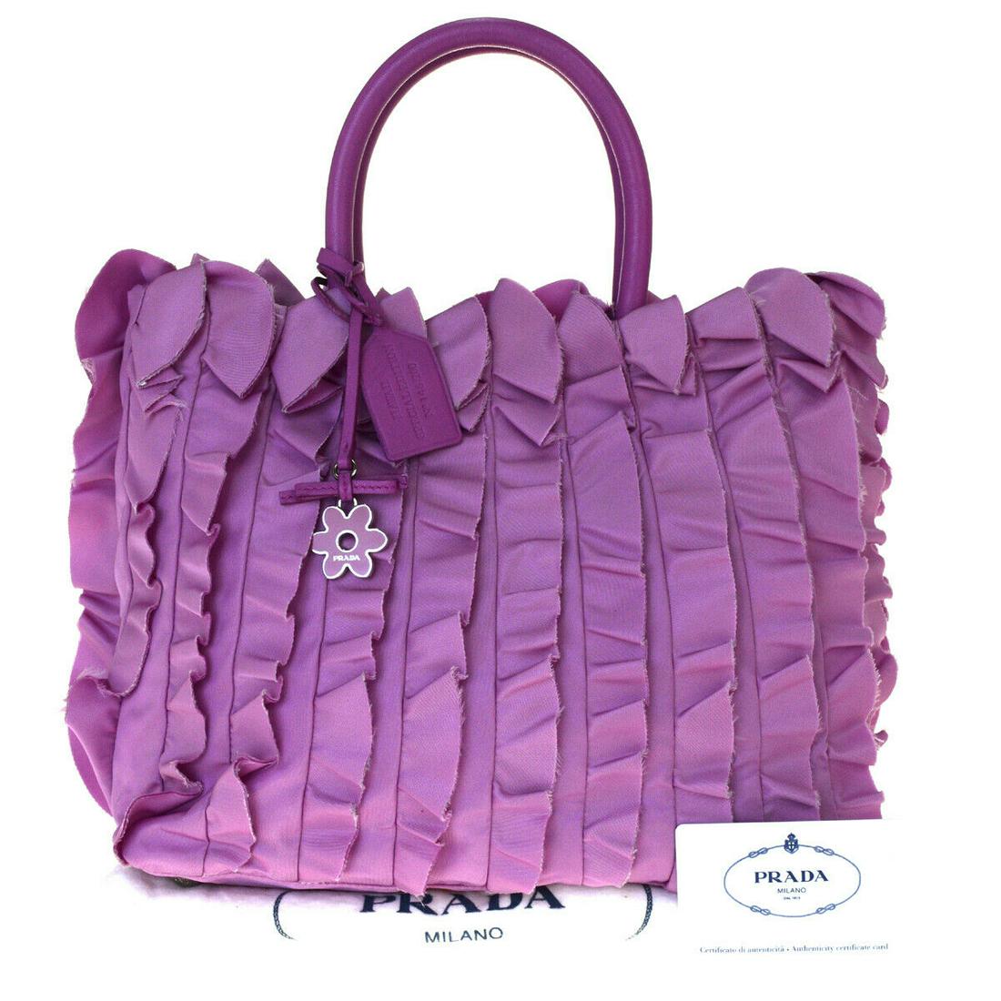 Authentic PRADA Nylon,Leather Hand bag: Brand: PRADA Material: Nylon,Leather Style: Hand bag Color: Purple,Pink Size(inch): W 11.8 x H 9.1 x D 5.9 "(approx.) Country of Origin: Italy Come with: Authenticity Card All Bidhaus items come with