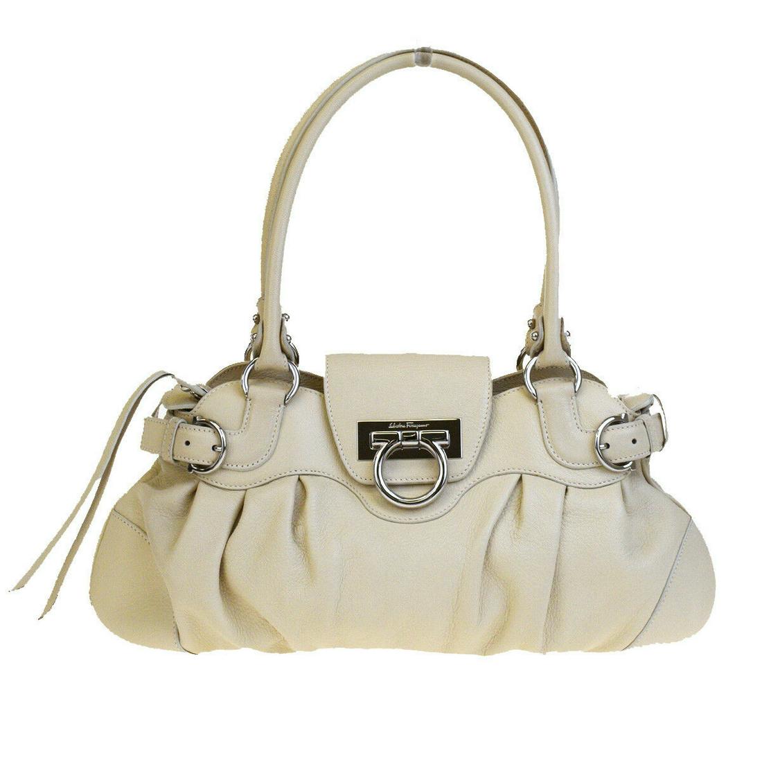 Authentic SALVATORE FERRAGAMO Leather Shoulder Bag: Brand: SALVATORE FERRAGAMO Material: Leather Style: Shoulder Bag Color: Ivory Size(inch): W 14.2 x H 7.9 x D 2.4 "(approx.) Country of Origin: Italy Come with: - All Bidhaus items come with a 100% mon