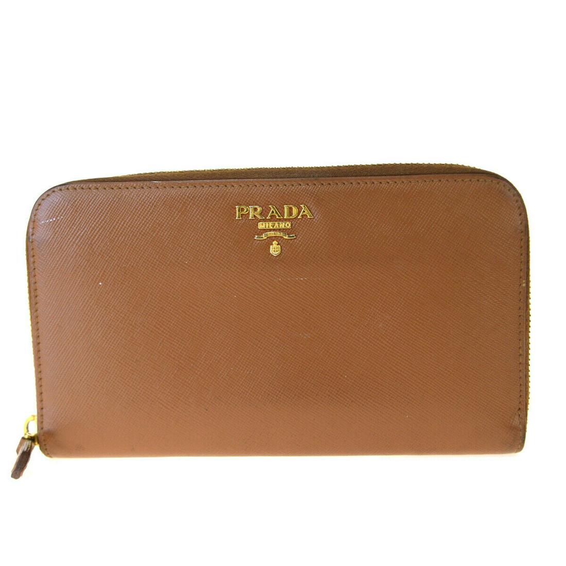Authentic PRADA Saffiano Leather Long Wallet: Brand: PRADA Material: Leather Color: Brown Size (HxWxD): 11cm x 18.5cm x 2cm / 4.33'' x 7.28'' x 0.78'' Country of Origin: Italy All Bidhaus items come with a 100% money-back authenticity guarantee.