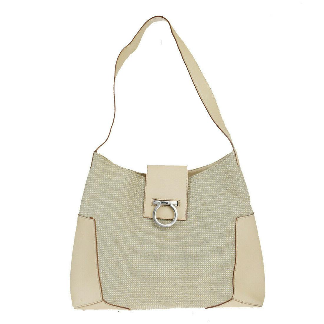 Authentic SALVATORE FERRAGAMO Canvas, Leather Shoulder: Brand: SALVATORE FERRAGAMO Material: Canvas, Leather Style: Shoulder bag Color: Beige Size (HxWxD): 22cm x 30cm x 8cm / 8.66'' x 11.81'' x 3.14'' Country of Origin: Italy All Bidhaus items come with a