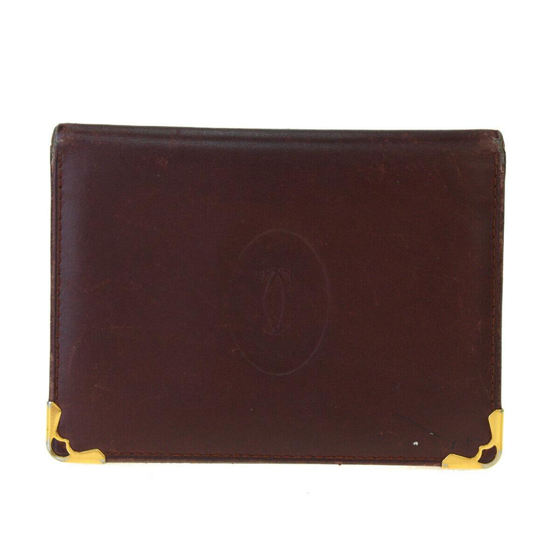 Authentic CARTIER Leather Card Wallet: Brand: CARTIER Material: Leather Color: Bordeaux Size (HxWxD): 8cm x 11cm x 2cm / 3.14'' x 4.33'' x 0.78'' Country of Origin: Spain All Bidhaus items come with a 100% money-back authenticity guarantee