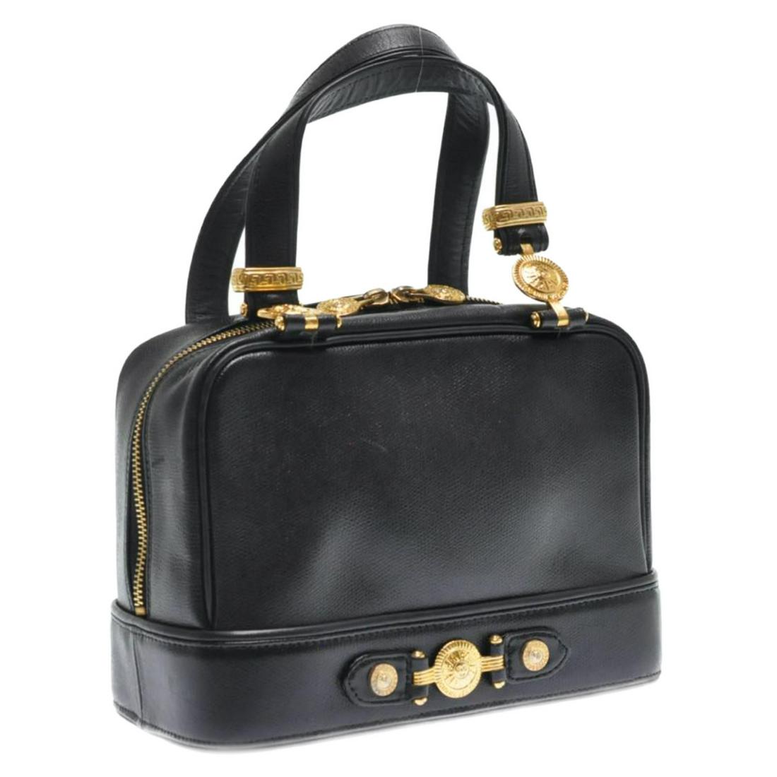 Authentic Gianni Versace Sun Face Hand Bag: Brand: Gianni Versace Style: Hand Bag Material: Leather Color: Black Made In: - Size (Inches): W9.84 X H6.69 X D4.72Inch(Approx) Exterior Condition: Leather : minor loose Shape Handle : minor Rubbing,