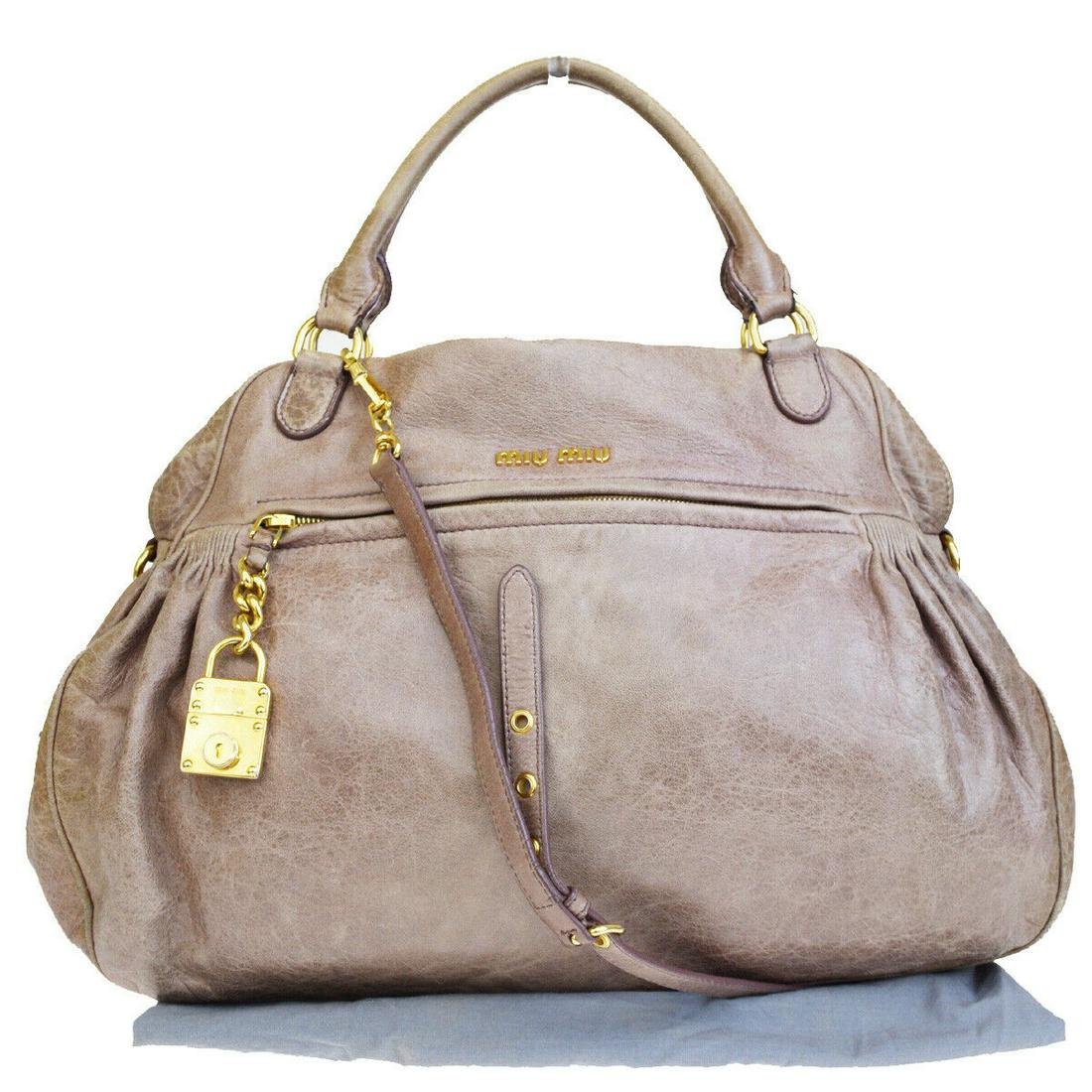 Authentic MIU MIU Leather Shoulder Bag: Brand: MIU MIU Material: Leather Style: Shoulder Bag Color: Pink Beige Size(inch): W 17.7 x H 12.6 x D 5.9 "(approx.) Country of Origin: Italy Come with: Dust bag,Shoulder strap All Bidhaus items come