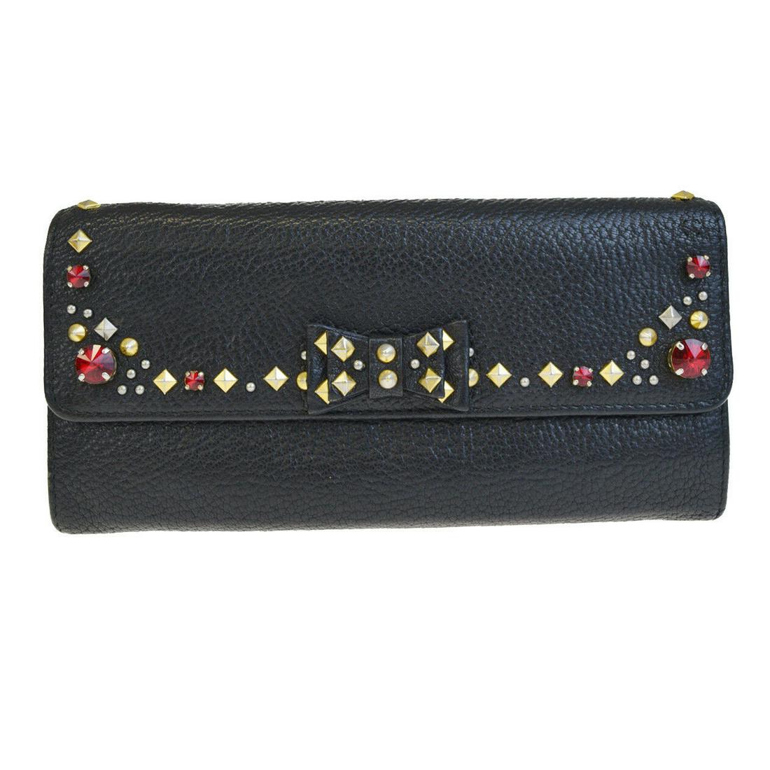 Authentic MIU MIU Leather Rhinestone Studded Wallet: Brand: MIU MIU Material: Leather Rhinestone Studded Style: Wallet Color: Black Size(inch): W 7.5 x H 3.7 x D 0 "(approx.) Country of Origin: Turkey Come with: - All Bidhaus items come with a 100% mone