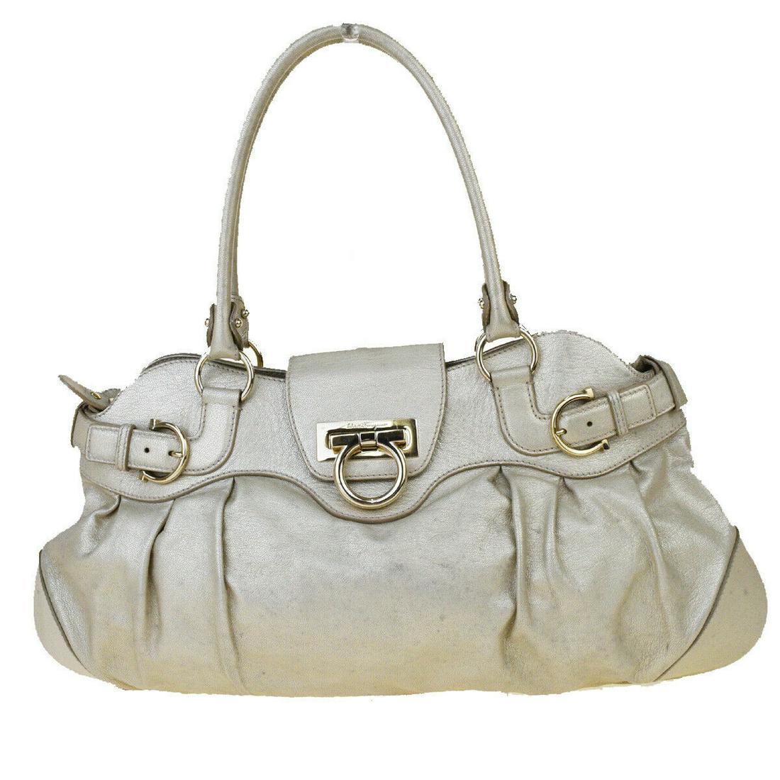 Authentic SALVATORE FERRAGAMO Leather Shoulder Bag: Brand: SALVATORE FERRAGAMO Material: Leather Style: Shoulder Bag Color: Metallic Ivory Size(inch): W 17.7 x H 9.1 x D 0.8 "(approx.) Country of Origin: Italy Come with: - All Bidhaus items come with a