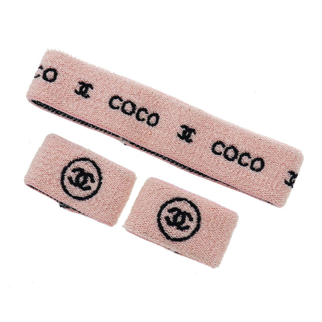 Authentic CHANEL CC COCO Logos Sports Line Hairband: Brand: CHANEL Material: Cotton Color: Pink Size(Inch): (Hairband) Inner circumference: 15.3 Width:1.4 (Wristband) Length:4.7 Width:1.5 Country of Origin: Unknown Come with: - All Bidhaus items come wi