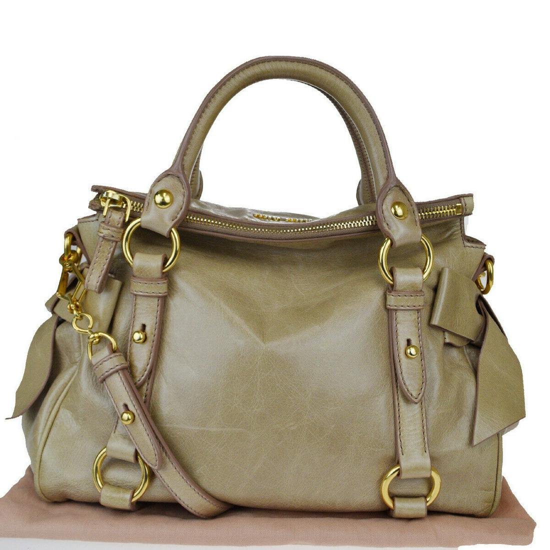 Authentic MIU MIU Leather Handbag: Brand: MIU MIU Material: Leather Style: Handbag Color: Beige Size (HxWxD): 22cm x 26cm x 13cm / 8.66'' x 10.23'' x 5.11'' Country of Origin: Unknown All Bidhaus items come with a 100% money-back authe