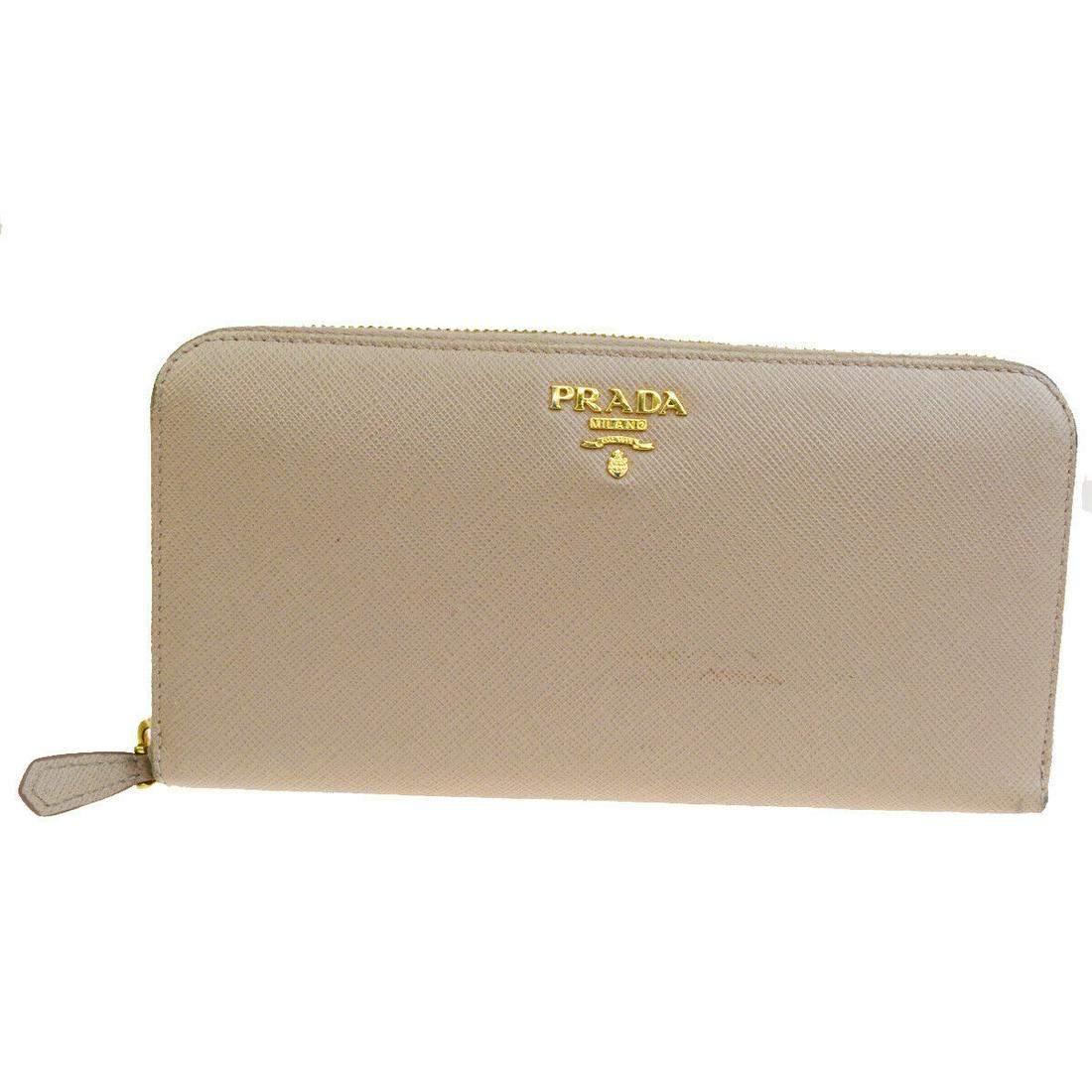 Authentic PRADA Leather Wallet: Brand: PRADA Material: Leather Style: Wallet Color: Pink Beige Size(inch): W 7.9 x H 4.3 x D 0 "(approx.) Country of Origin: Italy Come with: - All Bidhaus items come with a 100% money-back authentici