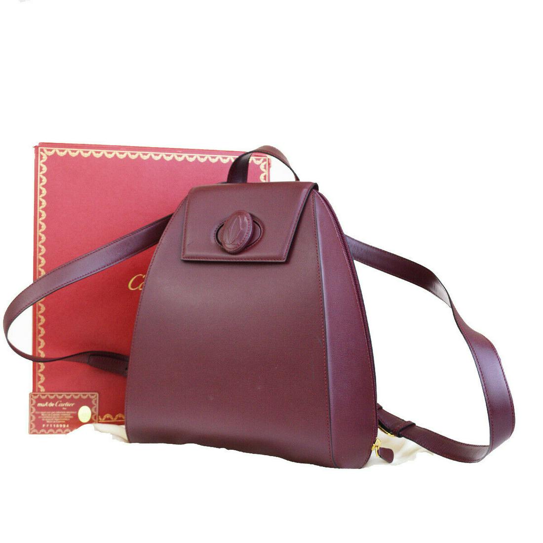 Authentic CARTIER Leather Backpack Bag: Brand: CARTIER Material: Leather Style: Backpack Bag Color: Bordeaux Size(inch): W 10.2 x H 11.8 x D 5.1 "(approx.) Country of Origin: France Come with: Box,Dust bag,Authenticity Card All Bidhaus item
