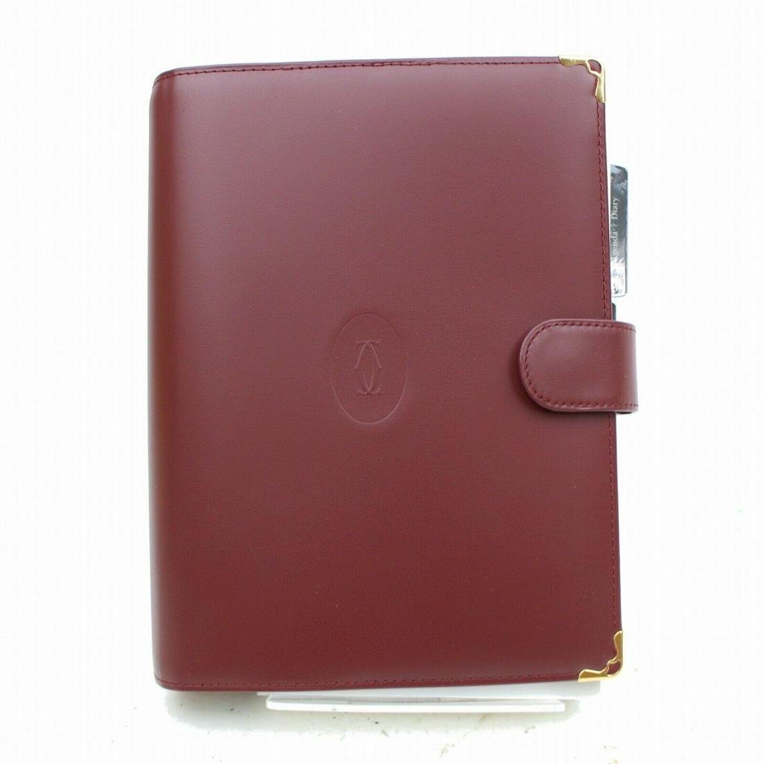 Authentic CARTIER Cowhide Leather Diary Cover: Brand: CARTIER Material: Cowhide Leather Style: Diary Cover Color: Bordeaux Come with: Original Box(Some Stains) / Guarantee Card / Leather Care Manual , Cloth , Refill for 2001 All Bidhaus items come