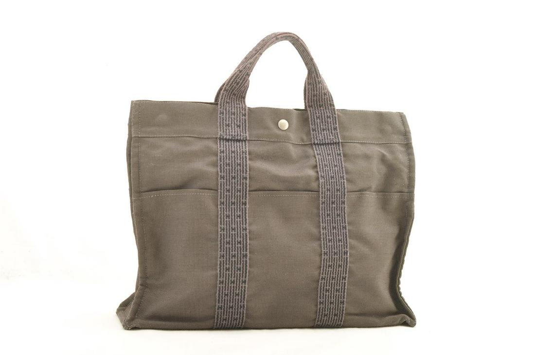 Authentic HERMES 69% Polyamide / 31% Polyester Tote Bag: Brand: HERMES Material: 69% polyamide / 31% Polyester Style: Tote Bag Color: Gray Size(inch): W16.5 x H11.8 x D3.9â€³(Approx) Country of Origin: France Accessory: Padlock(No Keys) All Bidhaus item