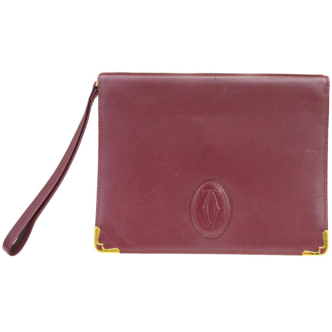 Authentic CARTIER Leather Clutch bag: Brand: CARTIER Material: Leather Style: Clutch bag Color: Bordeaux Size (HxWxD): 17cm x 22cm x 4cm / 6.69'' x 8.66'' x 1.57'' Country of Origin: Unknown All Bidhaus items come with a 100% money-back a
