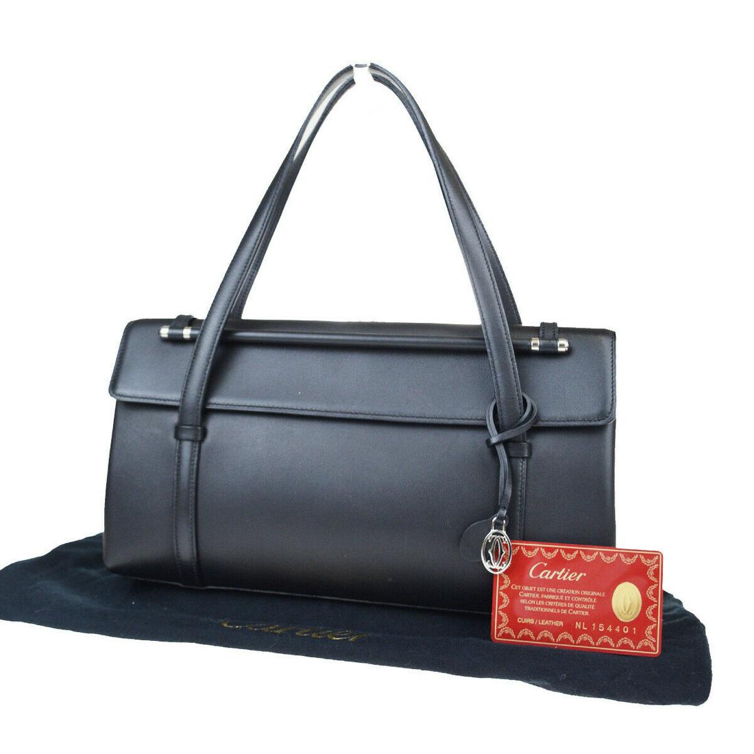 Authentic CARTIER Leather Hand Bag: Brand: CARTIER Material: Leather Style: Hand Bag Color: Black Size(inch): W 11 x H 6.3 x D 3.2 "(approx.) Country of Origin: - Come with: Charm,Dust bag,Authenticity Card All Bidhaus items come with a