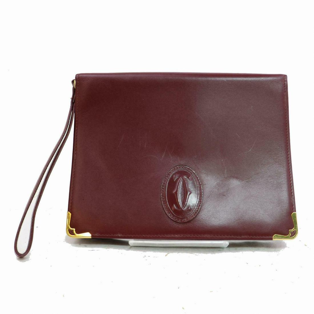 Authentic CARTIER Leather Clutch: Brand: CARTIER Material: Leather Style: Clutch Color: Bordeaux Size(inch): W9.05 inch(approx) /23 cm(approx) x H6.29 inch(approx) /16 cm(approx) x D1.18 inch(approx) /3 cm(approx) " Come with: Guarant
