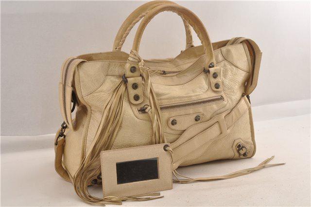 Authentic BALENCIAGA Leather Hand Bag: Brand: BALENCIAGA Material: Leather Style: Hand Bag Color: Cream Size(inch): W14.6 x H9.1 x D5.5" / Handle Drop 4.7"(Approx) Country of Origin: Italy Accessory: ShoulderStrap,Mirror All Bidhaus items 