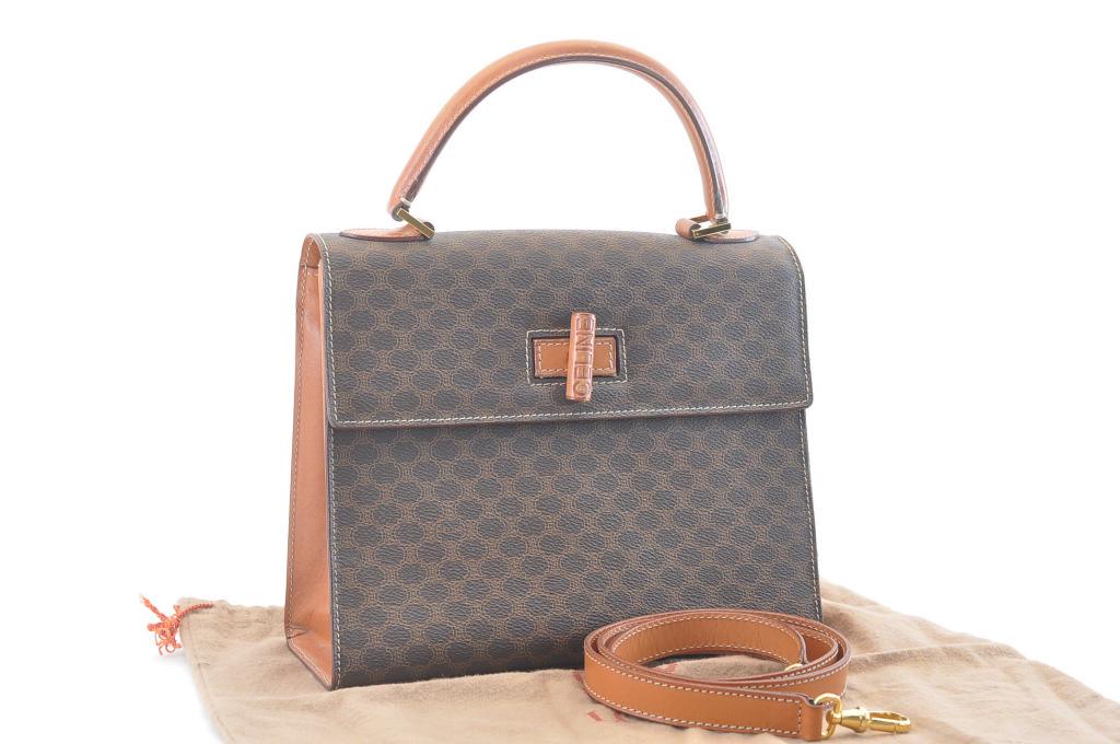 Authentic CELINE PVC Leather Hand Bag: Brand: CELINE Material: PVC Leather Style: Hand Bag Color: Brown Size(inch): W9.8 x H8.2 x D4.1â€³ / Strap Length 40.1â€³(Approx) Country of Origin: ITALY Accessory: Dust Bag / Strap All Bidha