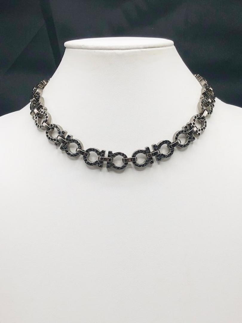 Salvatore Ferragamo Gunmetal Necklace with Black: Brand: Salvatore Ferragamo Material: Gun Metal Style: Necklace Color: Black Stones: Black Rhinestones Diameter(inch): 2.5 Country of Origin: Italy All Bidhaus items come with a 100% money-back authent