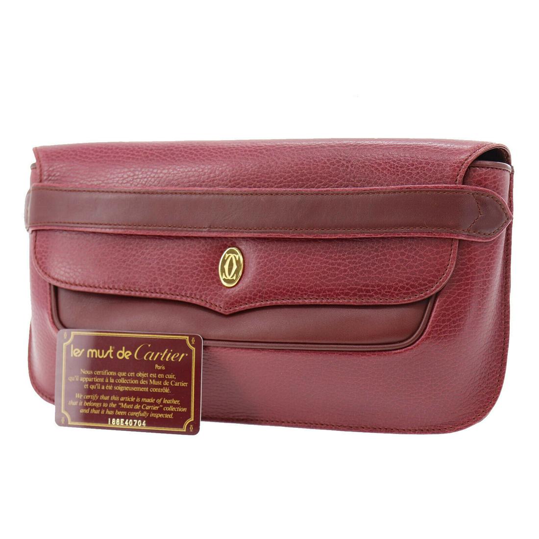 Authentic CARTIER Leather Clutch: Brand: CARTIERMaterial: LeatherStyle: ClutchColor: BordeauxSize(Inch): H 6.4 x D 1.3x L 11.0Country of Origin: SpainAll Bidhaus items come with a 100% money-back authenticity guarantee. ALL SALES ARE 