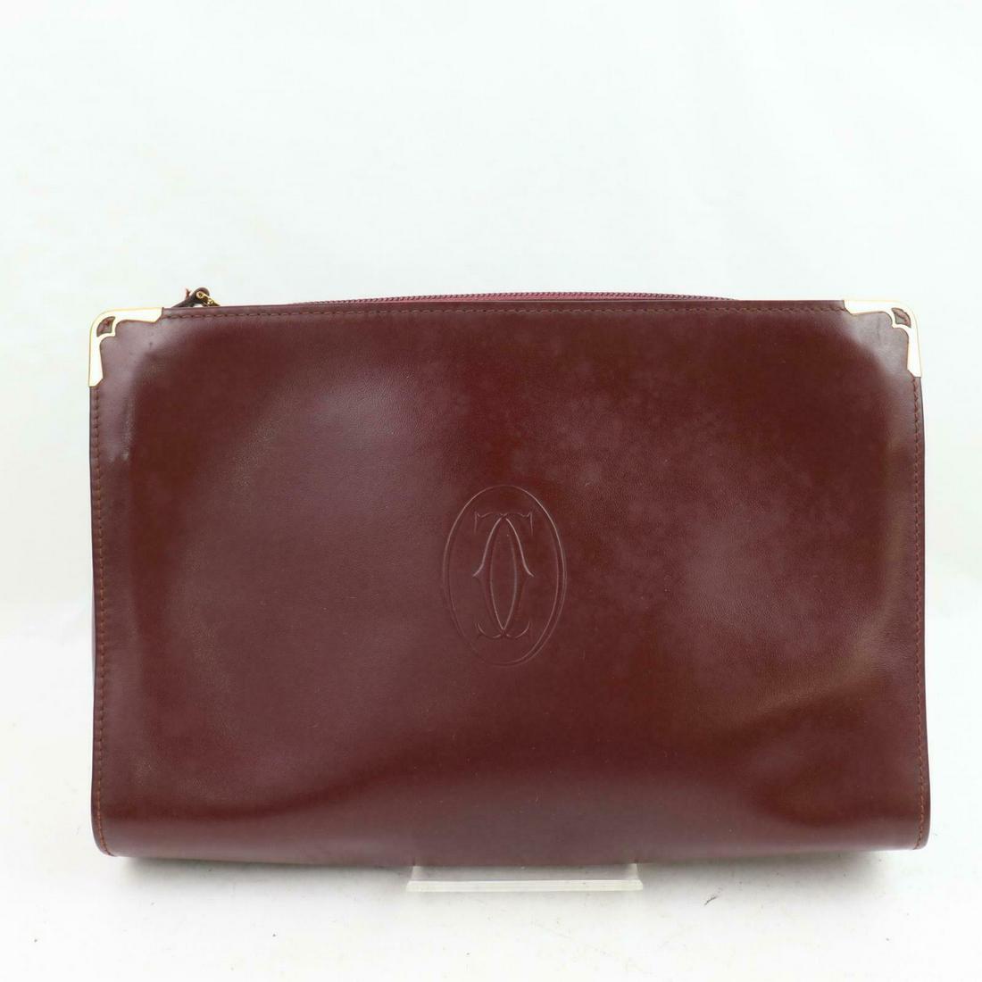 Authentic CARTIER Leather Clutch: Brand: CARTIERMaterial: LeatherStyle: ClutchColor: BordeauxSize(inch): W9.84 inch(approx) /25 cm(approx) x H6.29 inch(approx) /16 cm(approx) x D2.36 inch(approx) /6 cm(approx) "Come with: Serial No. C