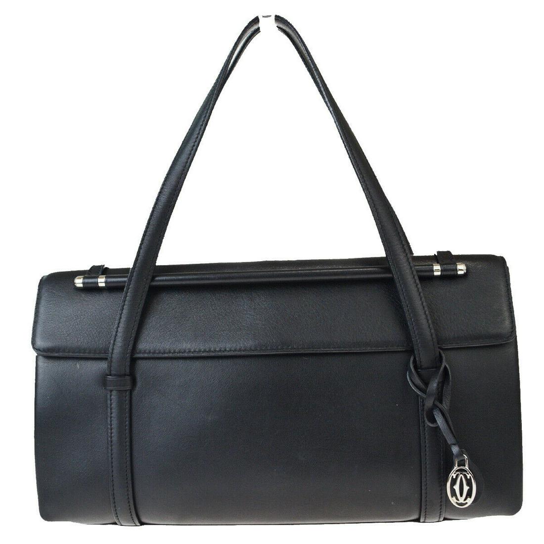 Authentic CARTIER Leather Hand Bag: Brand: CARTIERMaterial: LeatherStyle: Hand BagColor: BlackSize(inch): W 11 x H 5.5 x D 3.2 "(approx.)Country of Origin: -Come with: CharmAll Bidhaus items come with a 100% money-back authenticity guar