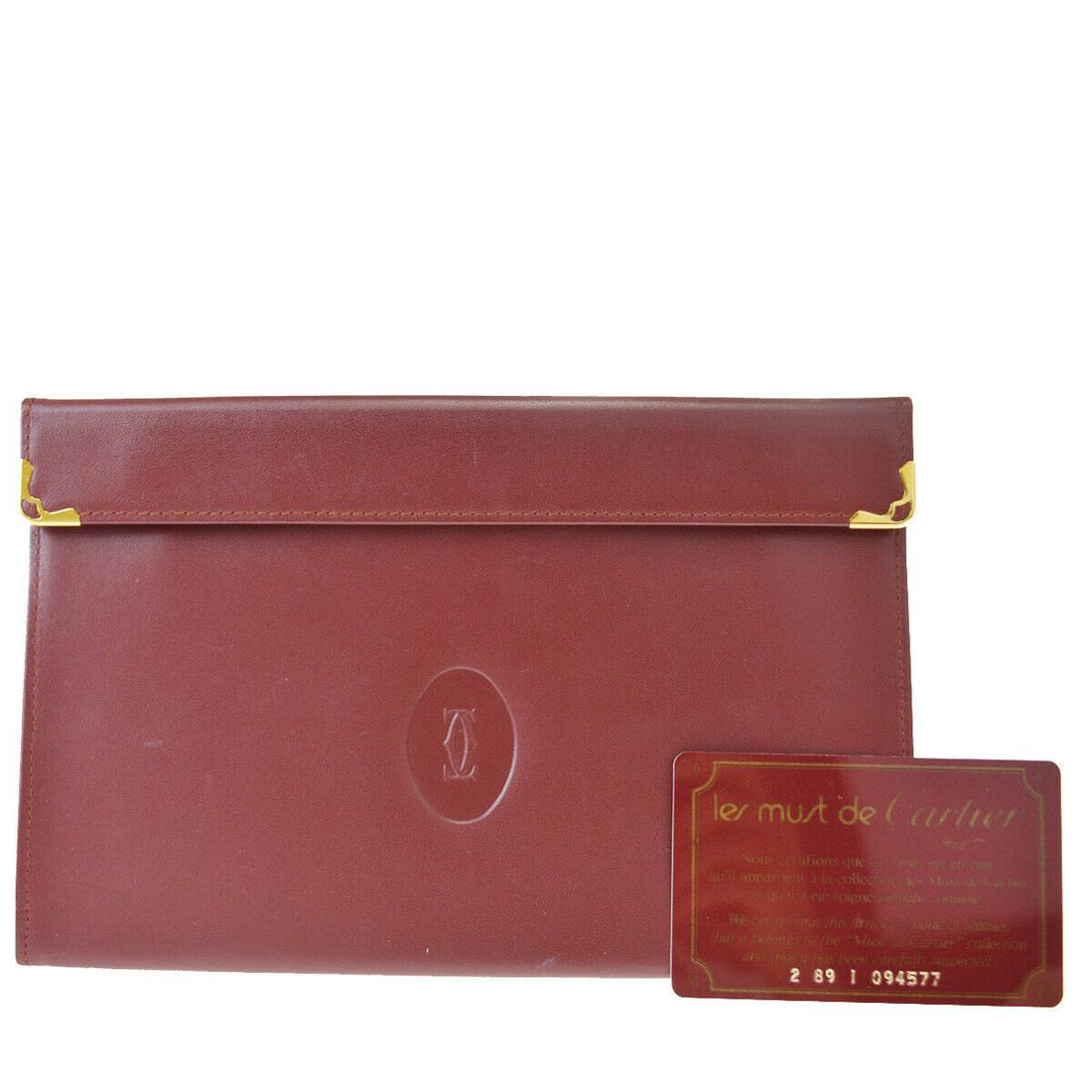 Authentic CARTIER Leather Clutch bag: Brand: CARTIERMaterial: LeatherStyle: Clutch bagColor: BordeauxSize(inch): W 7.7 x H 4.9 x D 2.4 "(approx.)Country of Origin: ItalyCome with: Authenticity CardAll Bidhaus items come with a 100% money-