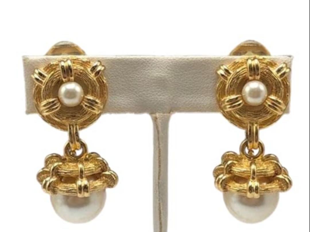 Authentic Dior Double Simulated Pearl Dangle Earrings: Brand: Dior Material: Gold-plated Style: EarringsClip Hallmark: "Chr Dior" Country of Origin: France All Bidhaus items come with a 100% money-back authenticity guarantee. ALL SALES ARE FINAL. Please r