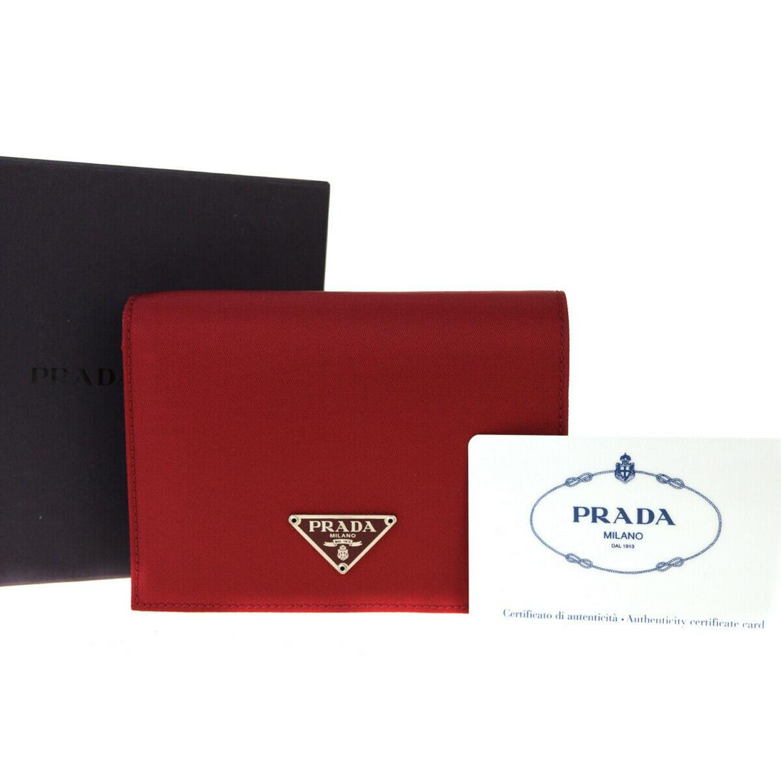 Authentic PRADA Leather, Nylon Wallet: Brand: PRADA Material: Leather, Nylon Style: Wallet Color: Red Size(inch): W 4.7 x H 3.9 x D 1.2 "(approx.) Country of Origin: Italy Come with: Box,Authenticity Card All Bidhaus items come with a 100%