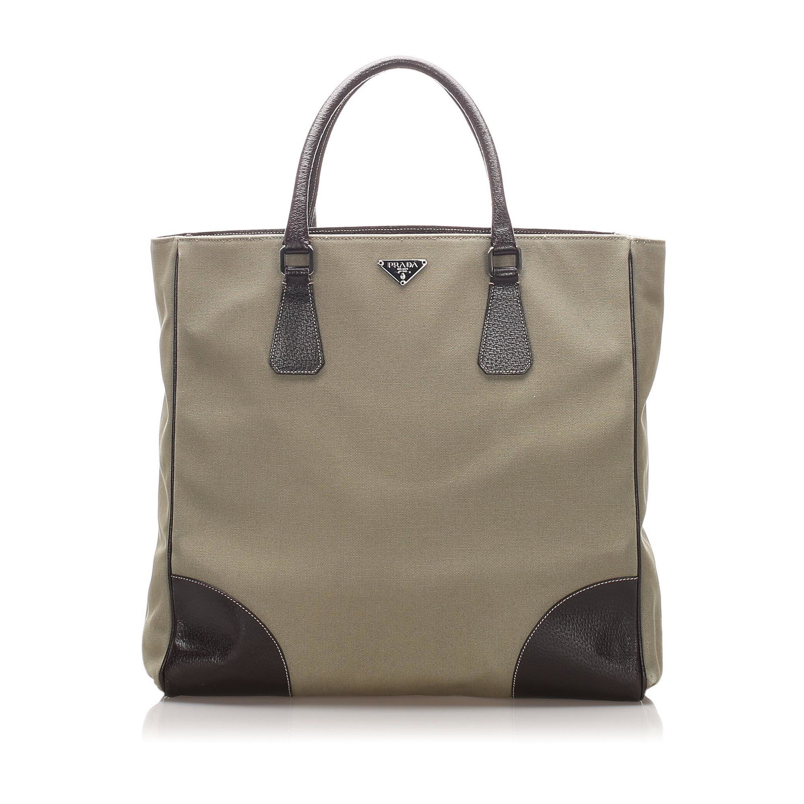 Authentic Prada Canapa Tote Bag: This tote bag features a canvas body with leather trim, rolled leather handles, an open top with magnetic snap closure, and interior zip and slip pockets.Brand: Prada Model: Canapa Tote Bag Origin: It