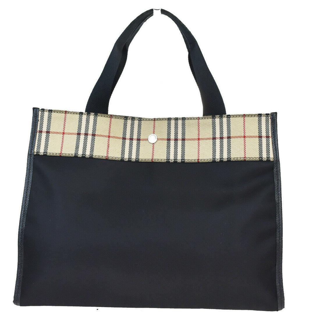 Authentic BURBERRY Nylon, Leather Handbag: Brand: BURBERRY Material: Nylon, Leather Style: Handbag Color: Black Size (HxWxD): 26cm x 34cm x 11cm / 10.23'' x 13.38'' x 4.33'' Country of Origin: Unknown All Bidhaus items come with a 100% money-b