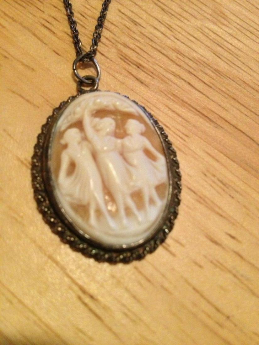 Authentic Sterling Silver, Carved Shell Three Graces: Material: Shell Color: Silver This is a lovely cameo depicting 3 dancing ladies, which are the three GracesThe chain necklace is 22 inches in length and made of sterling silver.The cameo is made of sh