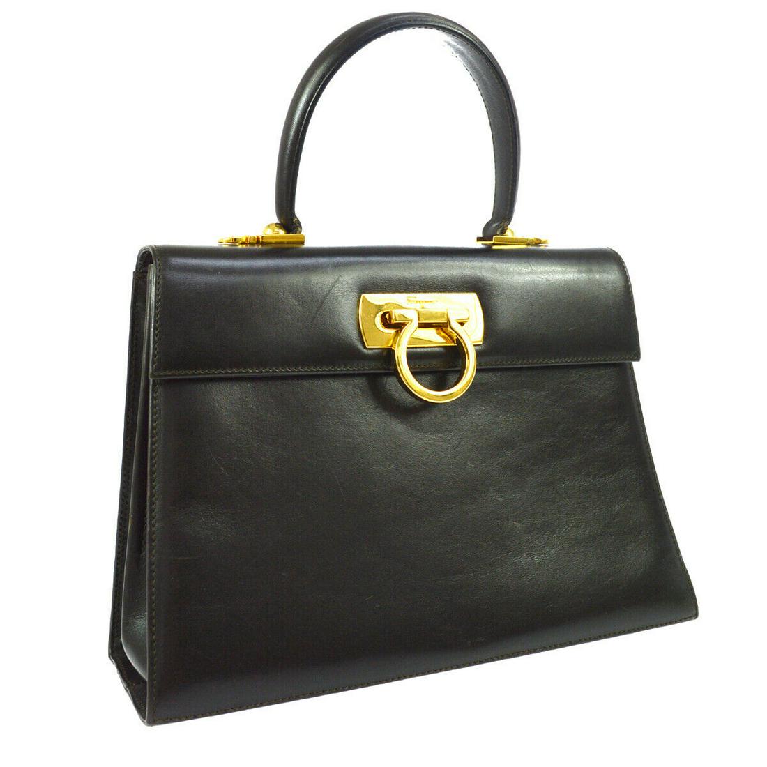 Authentic SALVATORE FERRAGAMO Leather Hand Bag: Brand: SALVATORE FERRAGAMO Material: Leather Style: Hand Bag Color: Dark Brown Size(inch): W10.6 x H7.5 x D3.9 " / Strap Drop: 3.7 Country of Manufacture: Italy Come with: Dust Bag All Bidhaus items c